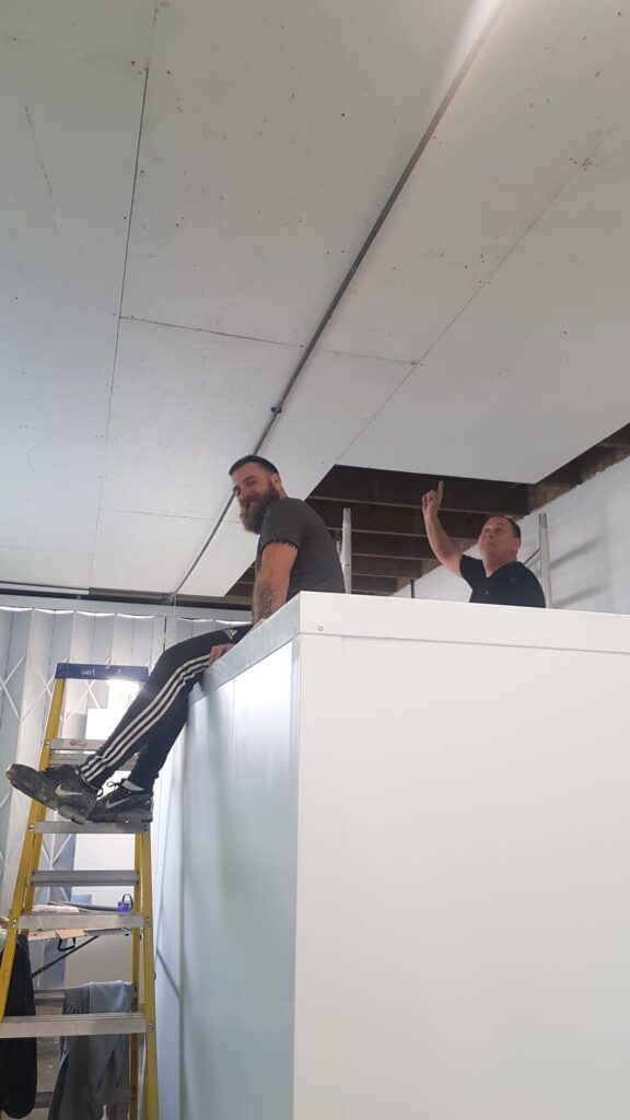 Tony and Matt volunteered to fit the ceiling boards. Members of the Alexander Wylie Foundation who run a food bank which Gratitude support.
